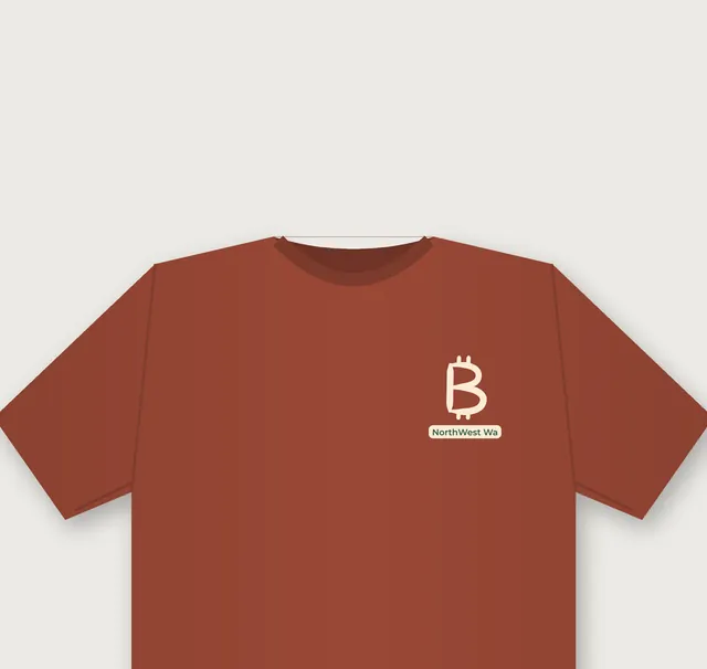 Clay-red tee with a small hand-brushed ₿ mark and a tiny NorthWest Wa tag on the left chest
